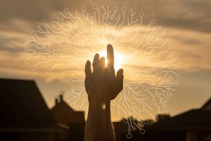 
Ręka wyciągnięta w kierunku słońca symbolizuje połączenie między ludzką świadomością a światem cyfrowym